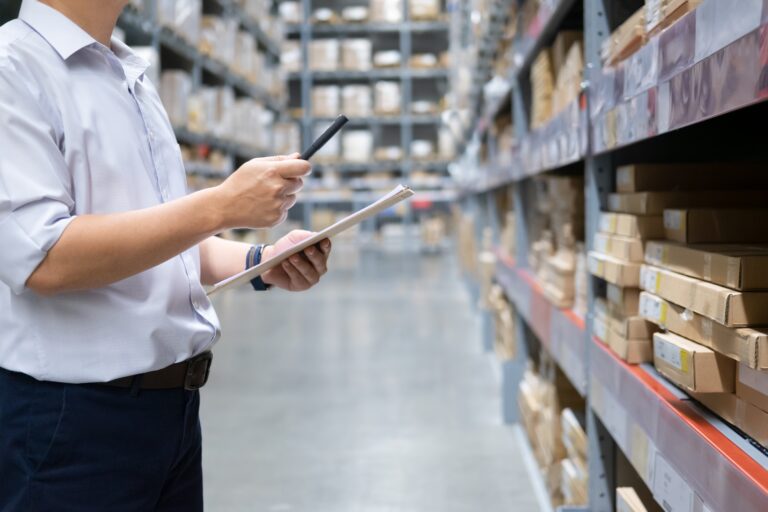 Man warehouse worker checking goods at warehouse